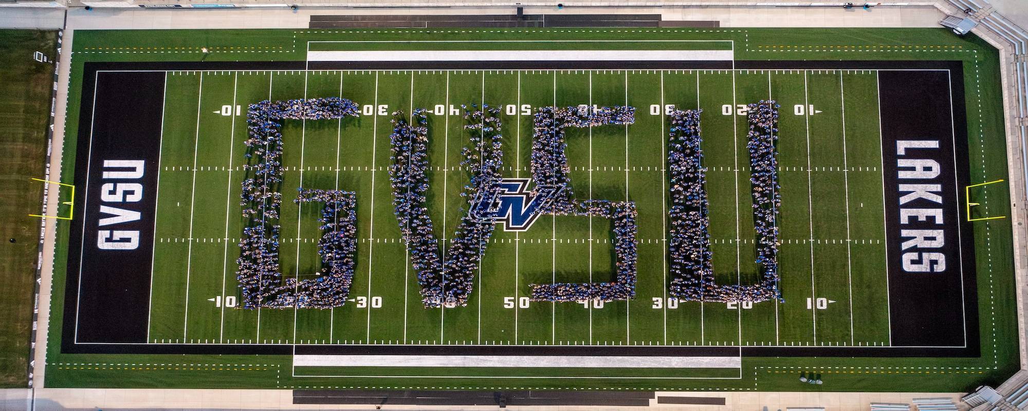 GVSU students forming the letters G, V, S, and U on the football field